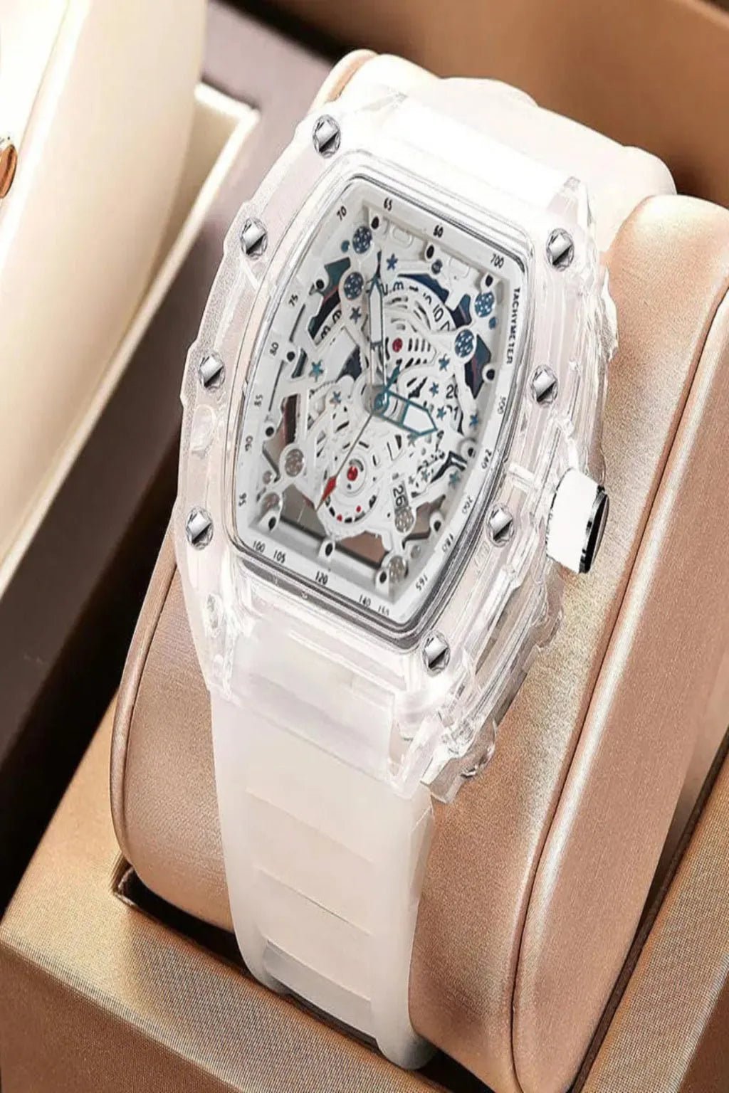 skeleton watch with intricate design and white silicone strap on a beige cushion available in UK at Dellnux