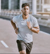 Man running on a road wearing smart watch with a blurred background UK